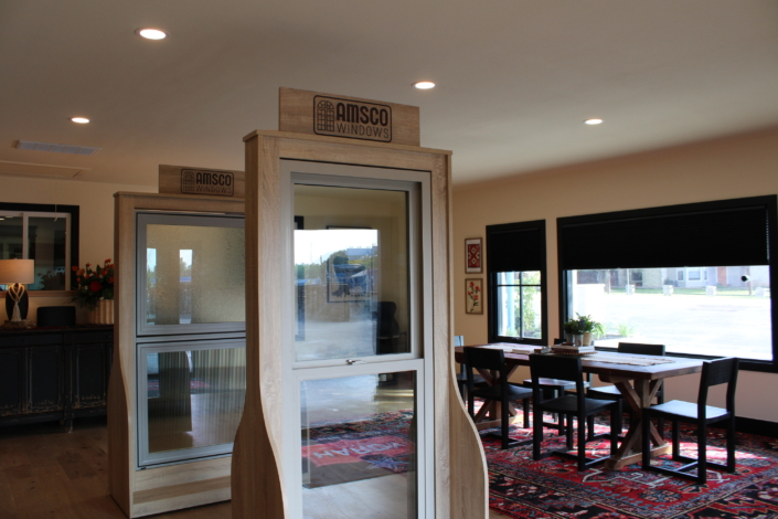 Amsco window display units beside black-framed showroom windows looking out to the parking lot