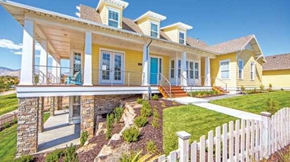 Yellow Austin home exterior showcasing energy efficient window replacement Austin, TX durability