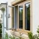 Modern exterior home window replacement with wood frames and energy-efficient glass