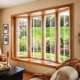 Bright living room featuring large energy-efficient bay windows with natural outdoor views