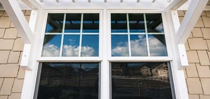 Window replacement in Austin, TX featuring energy-efficient white-framed windows on a residential home